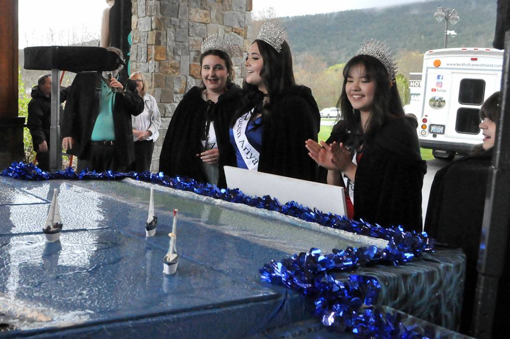Sequim Gazette photo by Matthew Nash/ Princess Ashlynn Northaven, Queen Ariya Goettling, Princess Kailah Blake, and Princess Sophia Treece take a closer look at their float for the 2024 season.