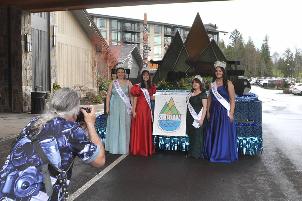 Sequim Gazette photo by Matthew Nash/ Photographer Keith Ross snaps photos of the Irrigation Festival royalty on March 23.