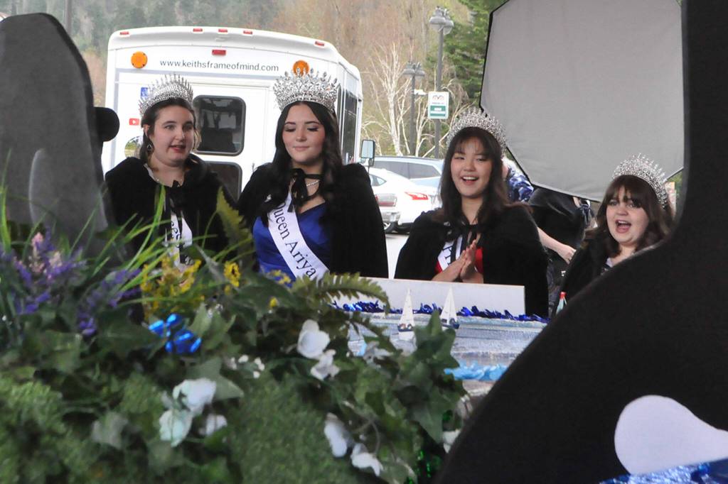 Sequim Gazette photo by Matthew Nash/ Princess Ashlynn Northaven, Queen Ariya Goettling, Princess Kailah Blake, and Princess Sophia Treece take a closer look at their float for the 2024 season.