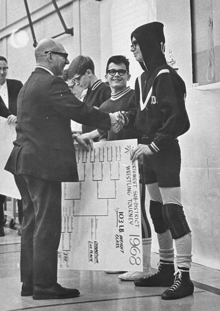 Photo courtesy of Randy Tomaras / Young Randy Tomaras, right receives honors from his father William at a wrestling tourney.