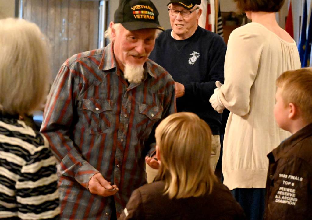 Sequim Gazette photo by Michael Dashiell / Vietnam War veteran Donald Pitkin, who served in the U.S. Army in 1968 and 1969, receives a commemorative pin and thanks from Junior American Eagles Donnie (8) and Henry (10) Fors at a ceremony honoring veterans on March 27.