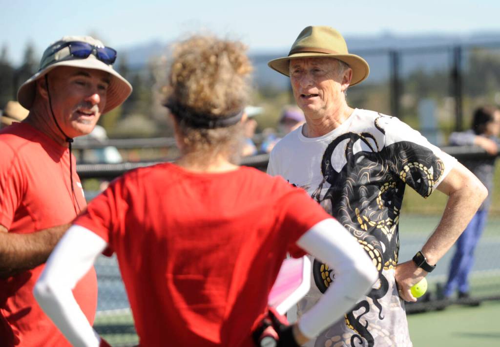 Sequim Gazette photo by Michael Dashiell / Chris Jafay, left, talks with X-40 Kraken teammates Phil Milliman and Jennifer Knapp during a break in a Sequim Picklers Minor League Pickleball match last week.