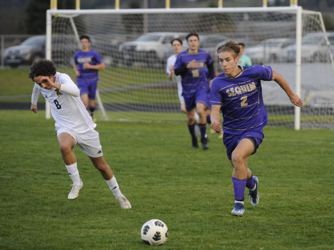 Sequim Gazette photo by Michael Dashiell / Sequims Preston Kurtze, right, dribbles downfield and looks for a teammate in the Wolves 3-2 loss against Bainbridge on March 26.