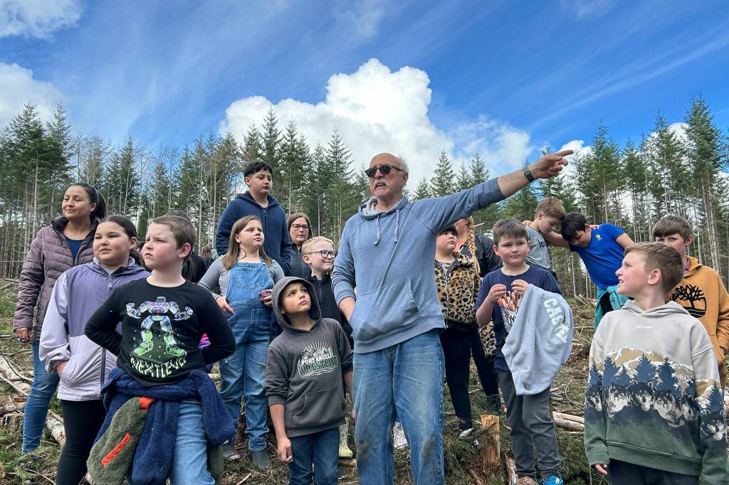 Sequim Gazette photo by Matthew Nash/ Volunteer Wayne Fitzwater talks to third graders about foresters efforts to manage trees and keep forests healthy in the Sequim area.