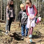 Sequim Gazette photo by Matthew Nash/ Emilee Sparrow digs as Sophia Sims and Maxton Imman look to help her plant a red cedar tree.