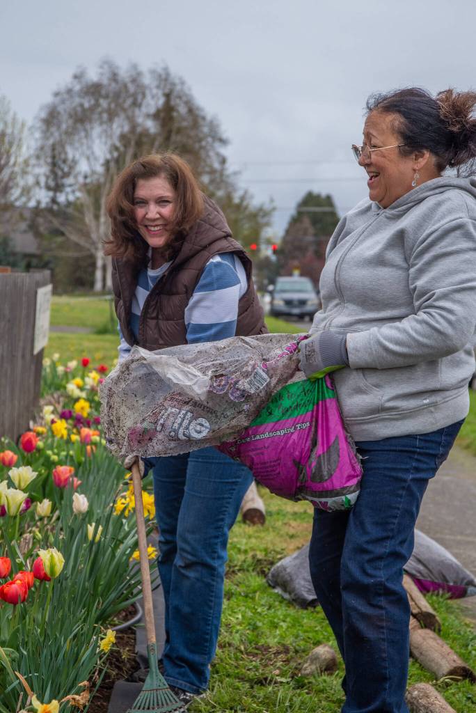 Photo by Emily Matthiessen / Jill Rochna, left, and Kimberly Salas work on the border of the COGS during Saturdays work-party. Rochna, who has been with the garden for around seven years, says that it brings joy to the community at large as well as to the gardeners. Its truly a community garden. When this place is in full swing, its beautiful. Salas says its her first year with a plot; she used to visit the garden on walks.