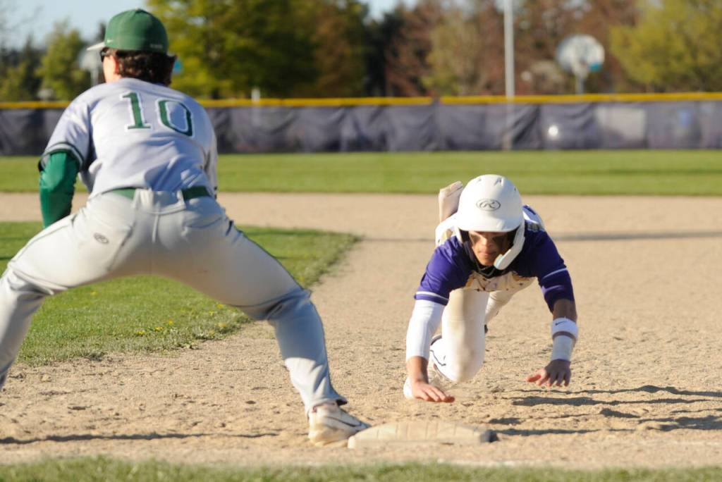 Sequim Gazette photos by Michael Dashiell
Sequims Bryant Laboy dives back to first base as Port Angeles first baseman Rylan Politika awaits a throw in SHSs 7-4 home loss to the Roughriders on April 12. Laboy was 2-for-4 with a double and RBI in the contest.