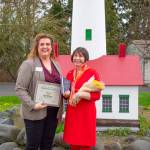 Beth Pratt, executive director of the Sequim-Dungeness Chamber of Commerce, presents Renne Emiko Brock with her 2023 Citizen of the Year award, which Pratt says is built around celebrating volunteerism and the spirit of collaborations.
