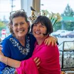 Photos by Emily Matthiessen
Laura Segil of La Petite Maison Blanche, left, shares a hug with Renne Emiko Brock at this months First Friday Art Walk, during which, we get a lot of visitors, Segil says. Local business owners and artists join forces during art walk to bring music, visual arts and food to roving groups of people.
