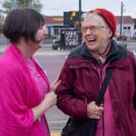Photo by Emily Matthiessen / Renne Emiko Brock, left, and fiber artist Pamela Hastings enjoy a laugh on Washington St during this months First Friday Art Walk, time of live music and art exhibitions around town that Brock founded 18 years ago and has been nurturing since.