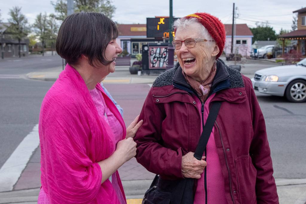 Photo by Emily Matthiessen / Renne Emiko Brock, left, and fiber artist Pamela Hastings enjoy a laugh on Washington St during this months First Friday Art Walk, time of live music and art exhibitions around town that Brock founded 18 years ago and has been nurturing since.