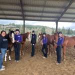 Photo by Misty Gilbertson / Sequim Equestrian Team coach Natalie Blankenship helps team members Katelynn Middleton-Sharpe, Celbie Karjalainen, Sydney Hutton and Taylor Lewis get ready for their showmanship event at the teams third district meet in Elma in mid-April.