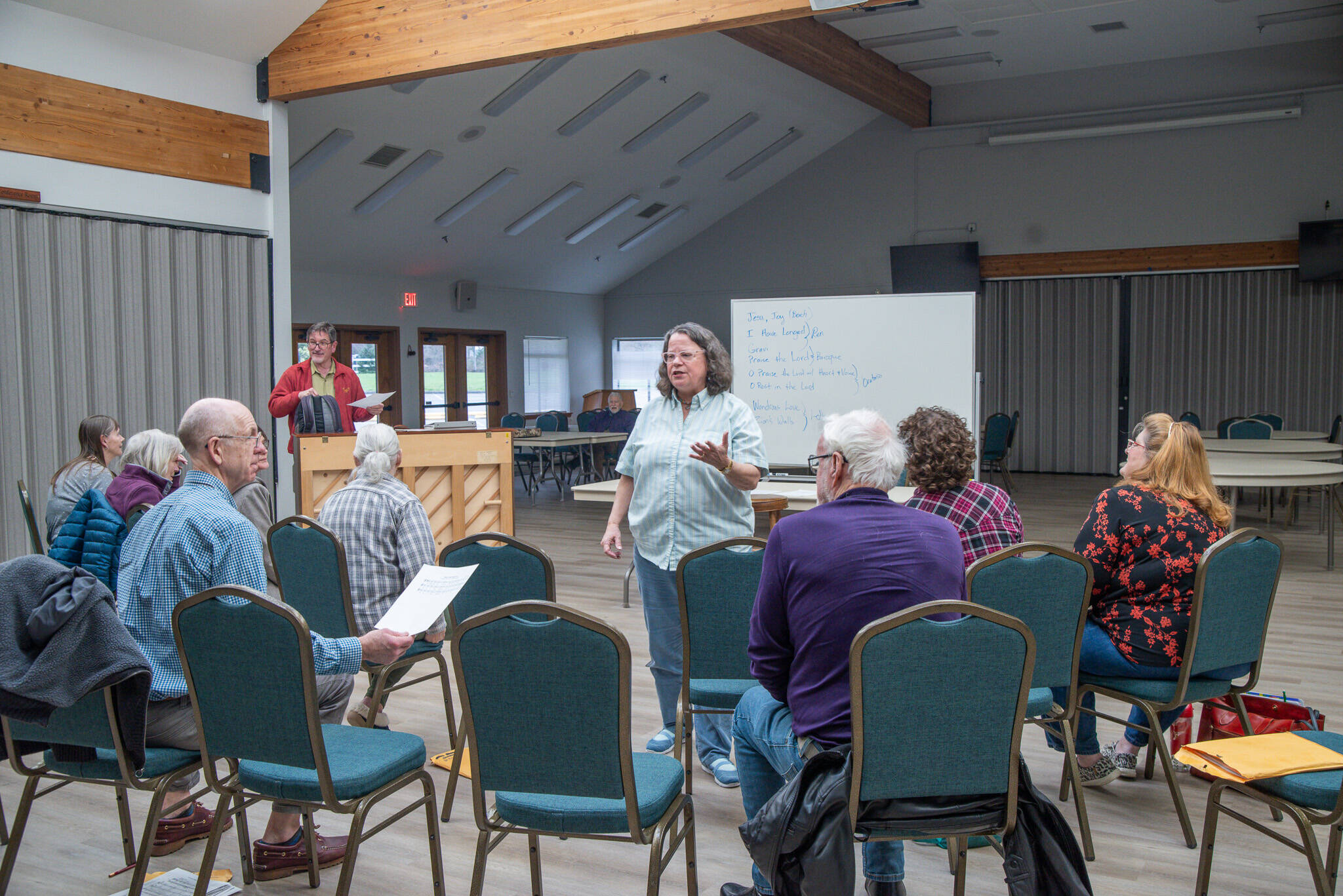Photo by Emily Matthiessen / Joan Reeve Owens, interim conductor with the Peninsula Singers, helps lead a rehearsal in early April. The group hosts their spring concert on Sunday, April 28, at Trinity United Methodist Church.