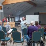 Photo by Emily Matthiessen / Joan Reeve Owens, interim conductor with the Peninsula Singers, helps lead a rehearsal in early April. The group hosts their spring concert on Sunday, April 28, at Trinity United Methodist Church.
