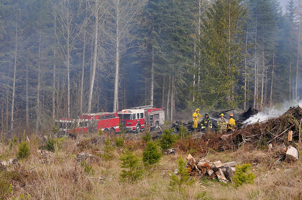 Sequim Gazette photo by Matthew Nash/ Clallam County Fire District 3 firefighters helped Department of Natural Resources firefighters to initially contain a slash pile fire that spread due to wind on April 15.