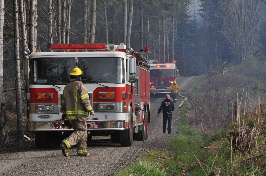 Sequim Gazette photo by Matthew Nash/ Clallam County Fire District 3 firefighters helped Department of Natural Resources firefighters to initially contain a slash pile fire that spread due to wind on April 15.