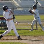Sequim Gazette photo by Michael Dashiell / With teammate Lincoln Bear looking on, Sequims Brayden White laces a single in the bottom of the fourth inning in an April 19 home game against Kingston.