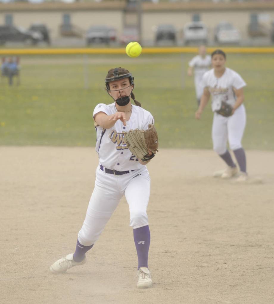Sequim Gazette photo by Michael Dashiell / With teammate Taylee Rome looking on, Sequim second baseman Mia Kirner throws out a Klahowya running in a non-league match-up on April 20.