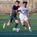 Photo by Keith Thorpe/Olympic Peninsula News Group
Port Angeles Jacob Weaver, left, fights for ball control with Sequims Evan Cisneros on April 16 at Peninsula College in Port Angeles.