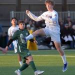 Photo by Keith Thorpe/Olympic Peninsula News Group / Sequims Finn Braaten, front, takes a header as Port Angeles A.J. Martinez keeps watch on April 16 at Peninsula College.