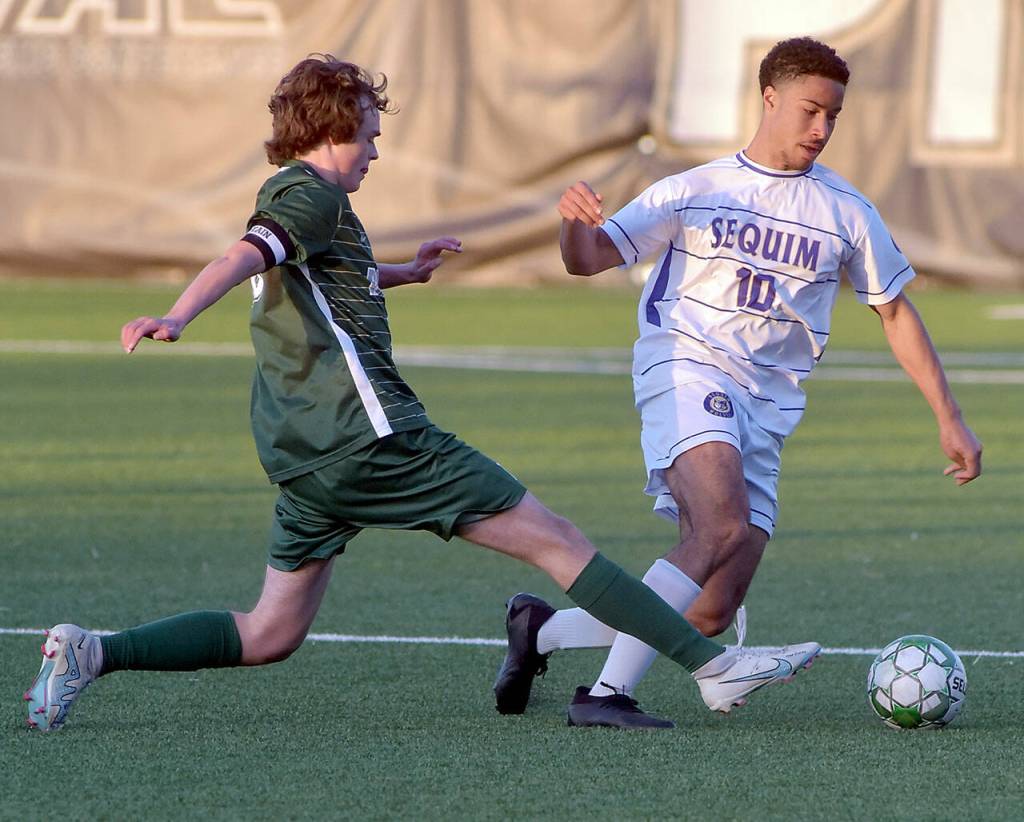 Photo by Keith Thorpe/Olympic Peninsula News Group / Sequims Mekhi Ashby, right, fends off Port Angeles Grant Butterworth on April 16 at Peninsula College.