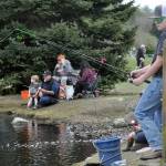 Landon Stubbins, 12, of Enumclaw, waits for a fish from the bridge by the Water Reuse Demonstration Pond. He attended Kids Fishing Day for the first time on a visit to his grandmother Marsha Smith of Sequim.