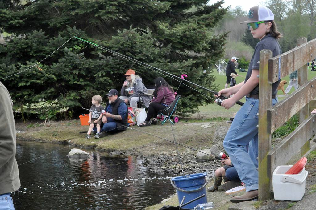 Landon Stubbins, 12, of Enumclaw, waits for a fish from the bridge by the Water Reuse Demonstration Pond. He attended Kids Fishing Day for the first time on a visit to his grandmother Marsha Smith of Sequim.