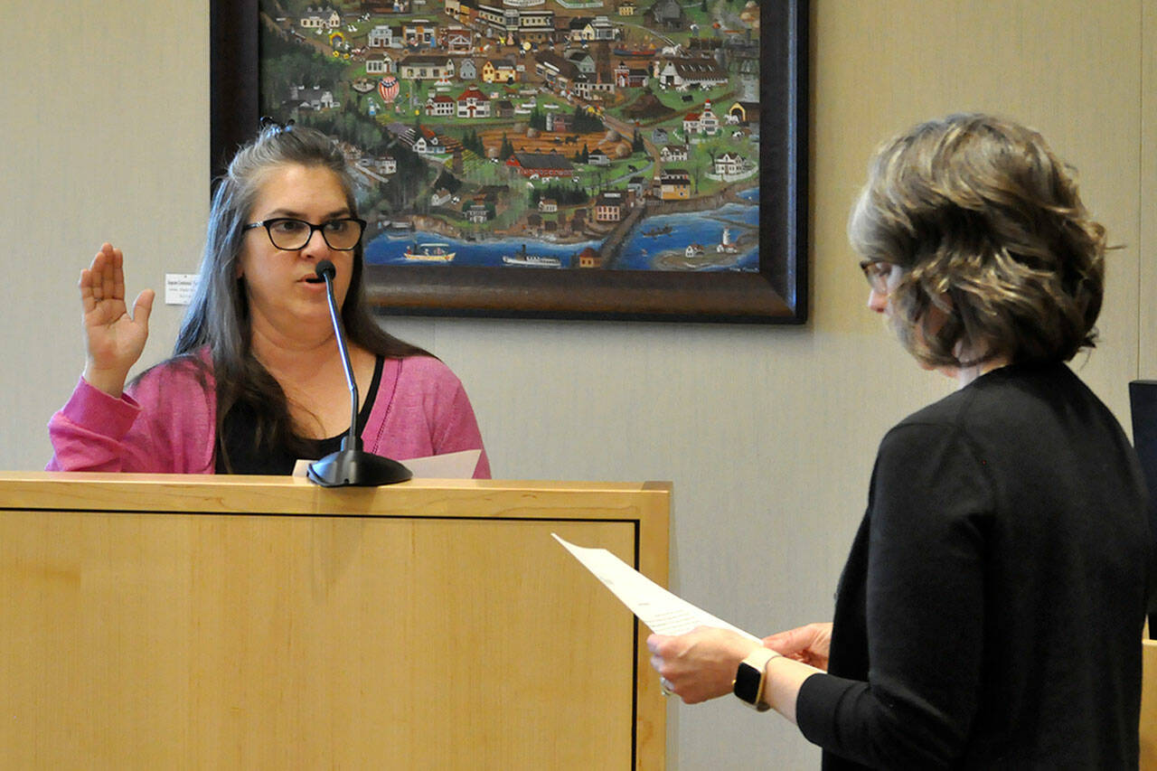 Sequim Gazette photo by Matthew Nash
Acting city clerk Heather Robley, right, swears in new city councilor Nicole Hartman on April 22 after she was appointed to fill former mayor Tom Ferrells seat. Shell serve through certification of the 2025 general election.