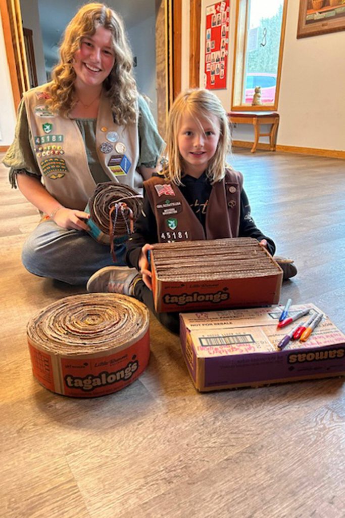Photo courtesy Heidi Krzyworz/ Girls Scouts with Troop 45181 Skylar Krzyworz and Malta Bushy sit with finished cat scratchers at Kitty City in Sequim.