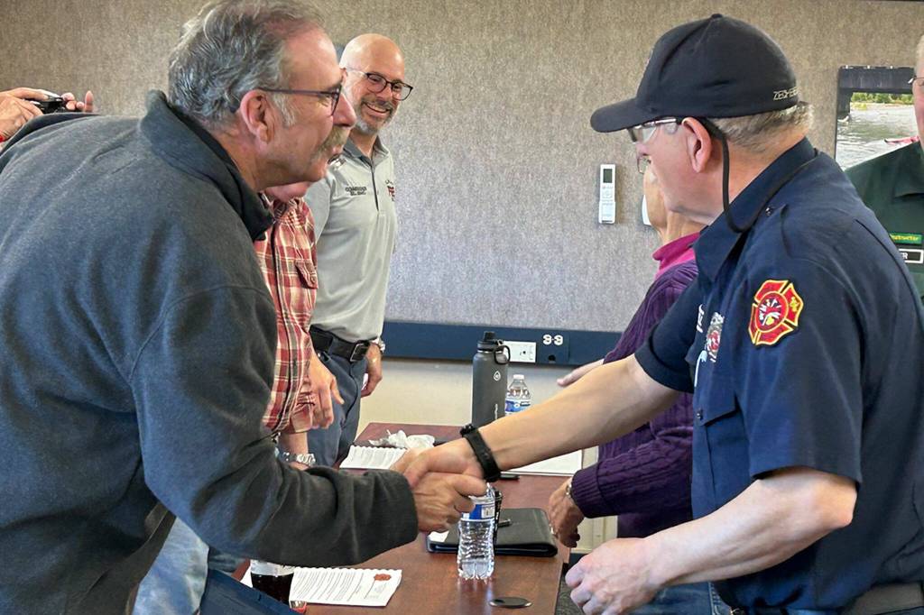 Sequim Gazette photo by Matthew Nash/ Clallam County Fire District 3 fire commissioners Mike Mingee, Jeff Nicholas, and Bill Miano congratulate Blaine and Cindy Zechenelly and the Community Emergency Response Team (CERT) for its continued success in supporting the community.