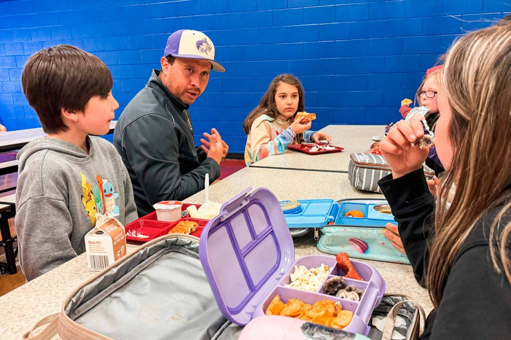 Dennis Laboy, a PenCom communications supervisor, talks to Helen Haller Elementary fifth graders during lunch on April 26 about his job working on emergency calls. He was joined by other first responders on Friend a First Responder Day.