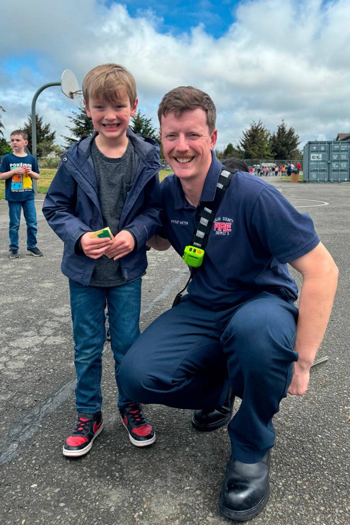 Photo courtesy Greywolf Elementary
Firefighter Ryan Hueter with Clallam County Fire District 3 goes to recess with his son Hudson on April 26 during Friend a First Responder Day at Greywolf Elementary.