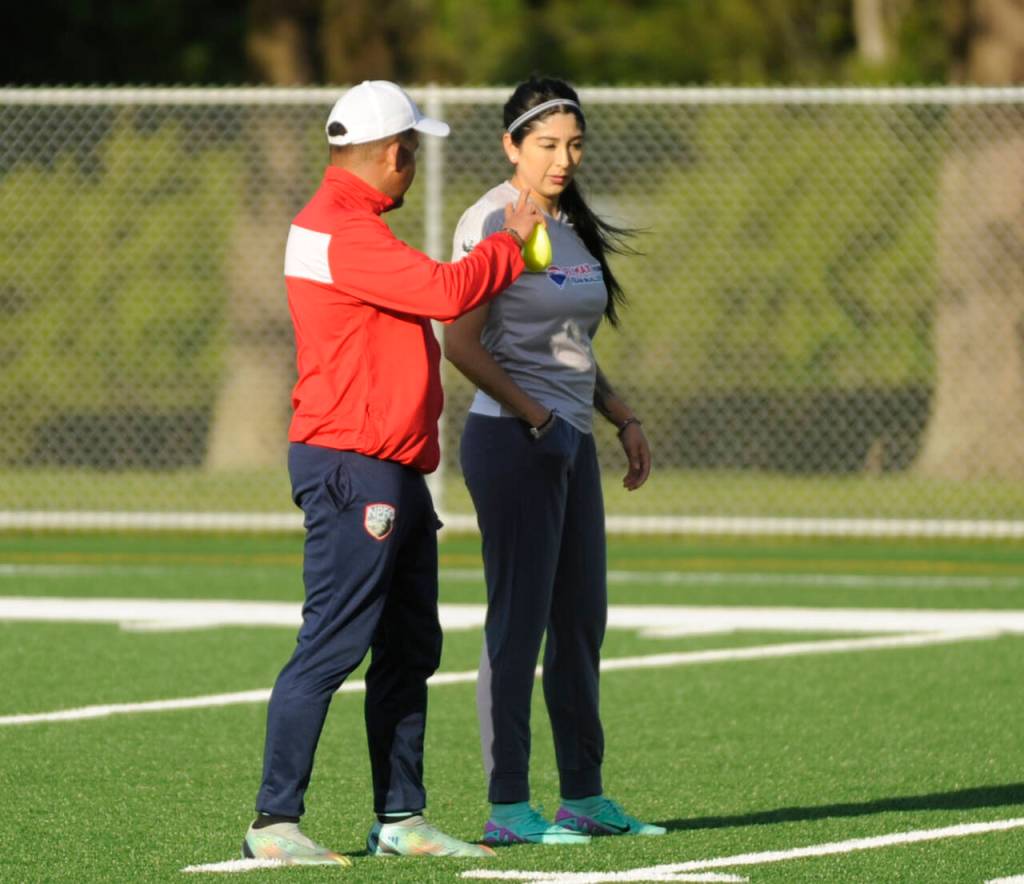 Sequim Gazette photo by Michael Dashiell / North Peninsula Football Club coach Juan Carlos Cisneros speaks with Lupita Pérez at a practice in Port Angeles on May 7.