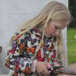 Sequim Gazette photo by Matthew Nash/ Ruby Miller, 6, carefully cuts along the edges of a crown she makes on May 4 during the Sequim Irrigation Festivals Family Fun Days.