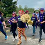 Sequim Gazette photo by Matthew Nash/ Teacher Sarah Castell leads students from the Helen Haller Elementary Kindness Squad in the Kids Parade on May 4.