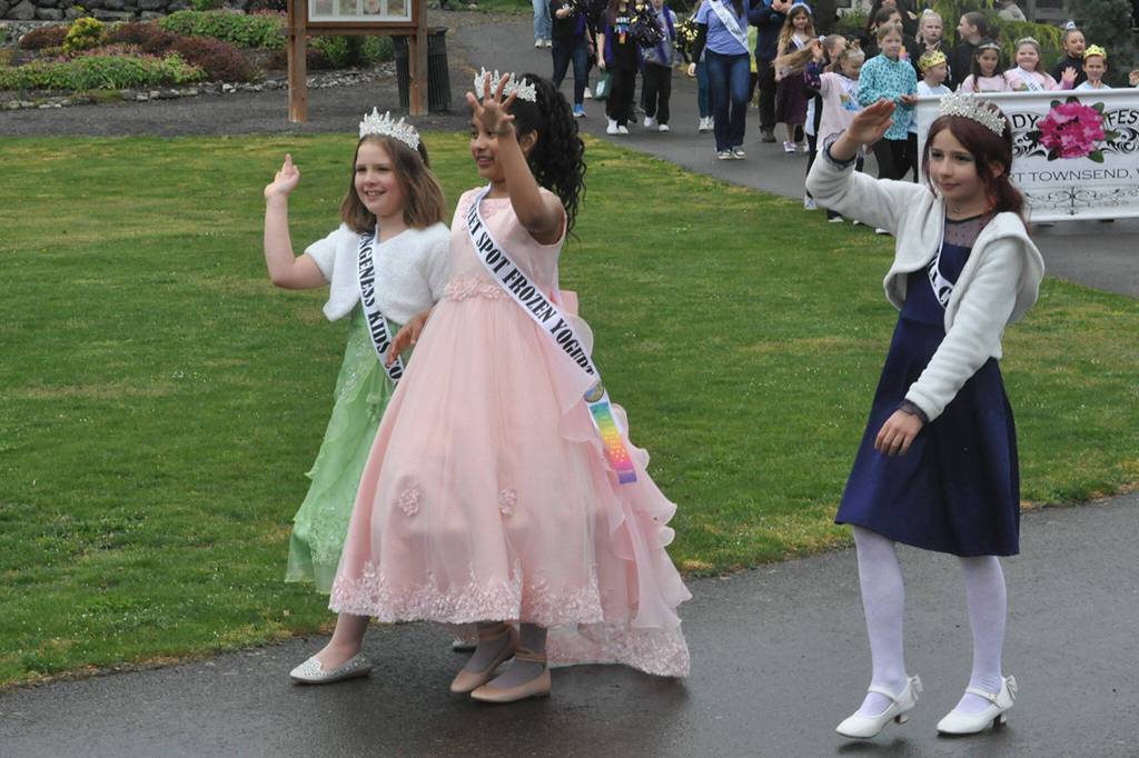 Sequim Gazette photo by Matthew Nash/ Irrigation Festival junior royalty, from left, princesses Ruby Sly-Hobson, 9, Dulce Villegas, 9, and Olive Gockerell, 9. wave to the crowd during the Kids Parade on May 4.
