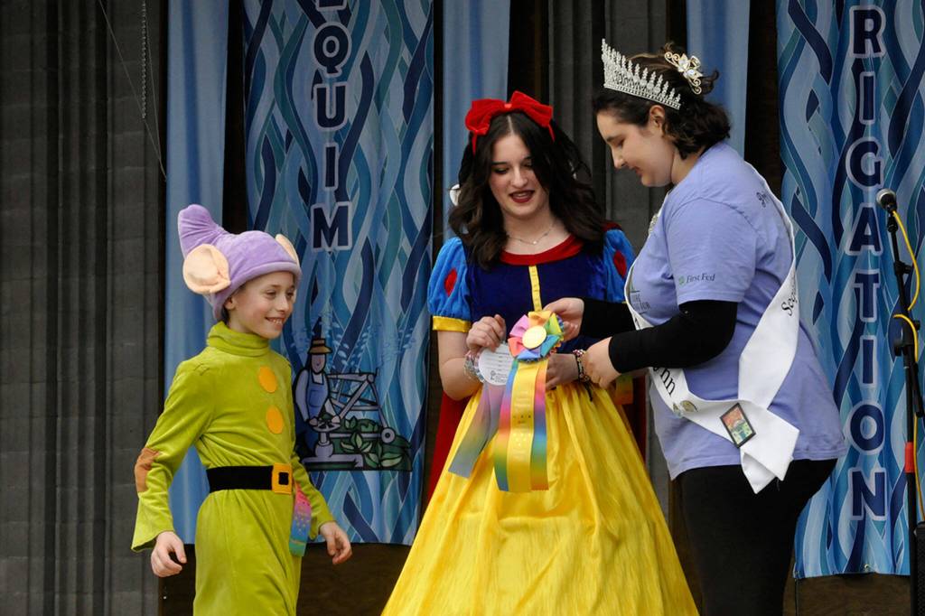 Sequim Gazette photo by Matthew Nash/ Sister and brother Mylee Beeter, 12, and Braylen Williams, 9, win the Grand Prize during the Kids Parade on May 4 with Princess Ashlynn Northaven giving them the ribbons for their Snow White and Dopey costumes. Theyll appear in the Grand Parade on May 11, and Mylee said she hopes to be on the royalty court someday.