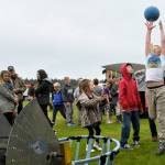 Nine-year-old Thomas Bagley of Sequim extends up to catch a ball from Juggle Jaw, a robot built by the Sequim High Schools Robotics Club. The team made it to district championships this school year, students said.