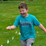 Bennett Castell, 9, an Irrigation Festival junior royalty member, runs fast with an egg during a relay race at Family Fun Days on May 4.