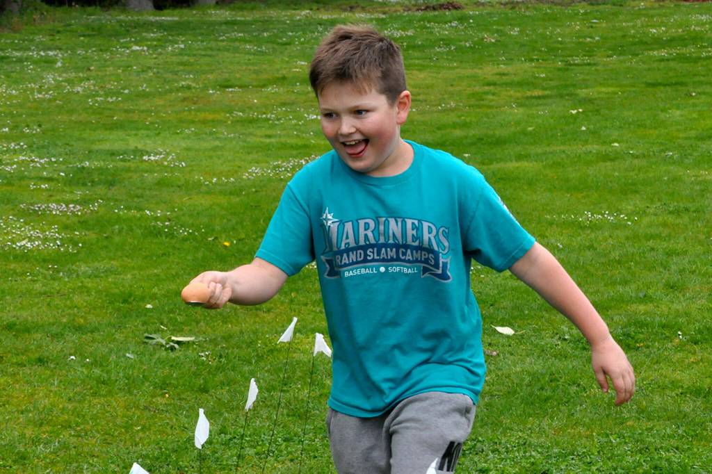 Bennett Castell, 9, an Irrigation Festival junior royalty member, runs fast with an egg during a relay race at Family Fun Days on May 4.