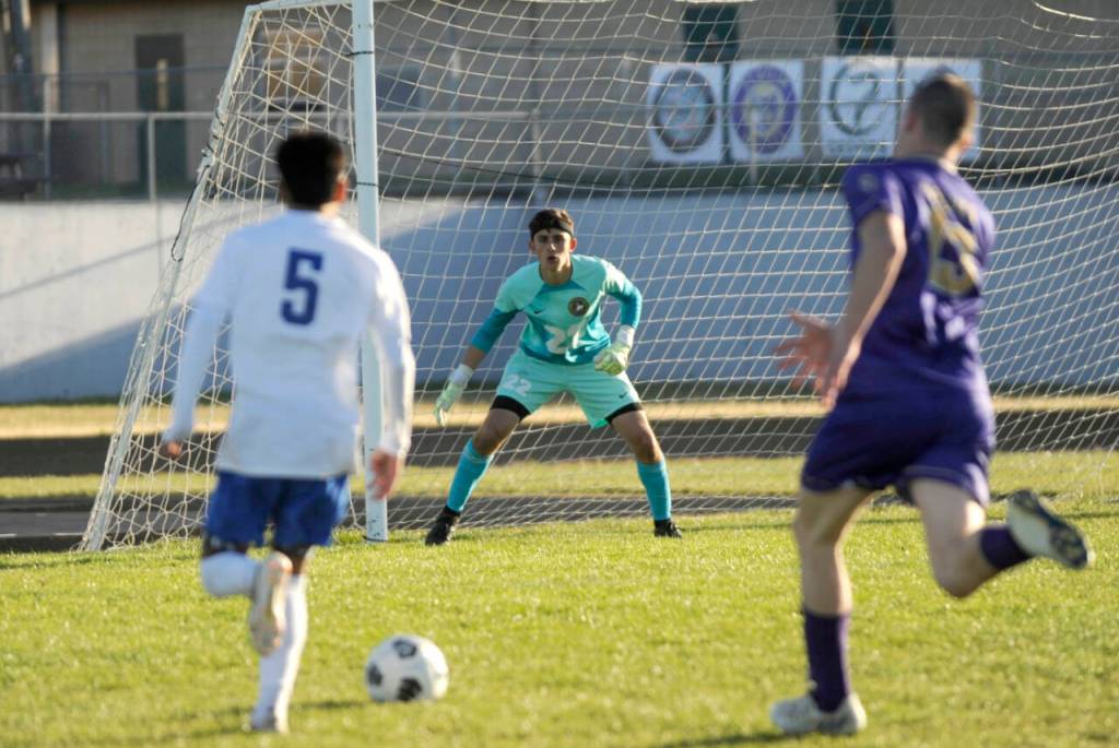 Sequim Gazette photo by Michael Dashiell / Sequim goalkeeper Nolan Valenzuela, center, keeps an eye on Bremerton attacker Adrian Ortiz, left, in the Wolves Olympic League home game on April 30. Bremerton edged the Wolves, 4-3.