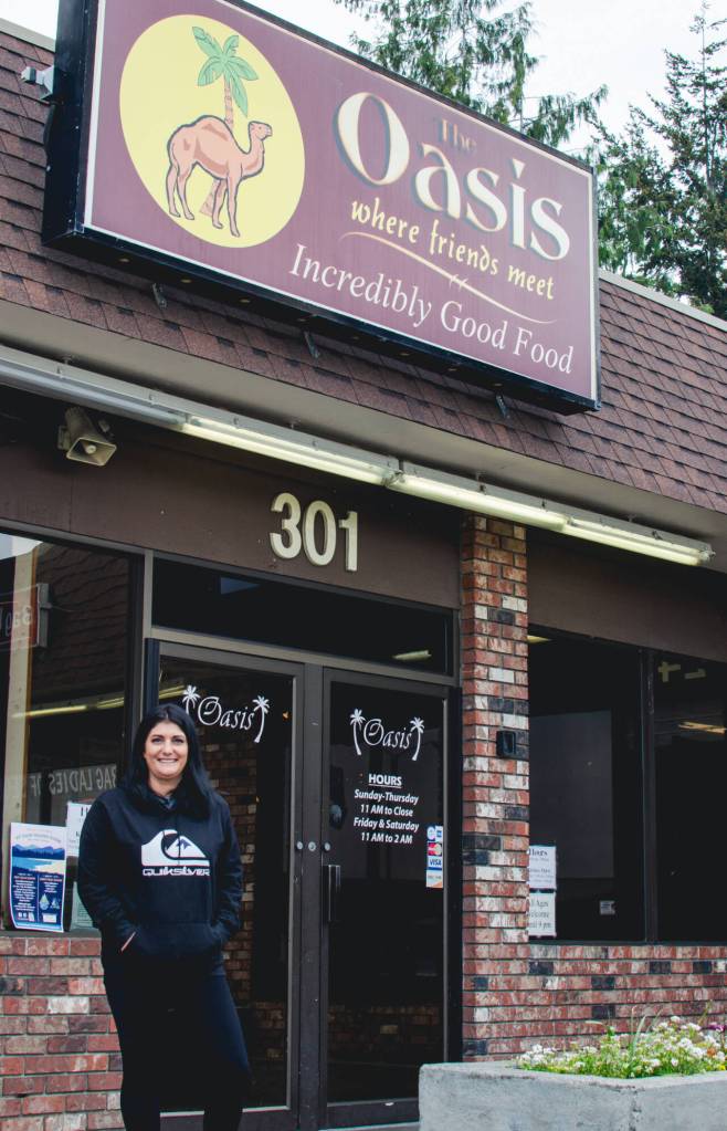 Sequim Gazette photo by Elijah Sussman / New owner Carly Rasmussen stands in front of The Oasis Bar and Grill in Sequim on May 3.
