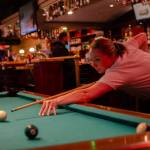 Sequim Gazette photo by Elijah Sussman / Angie Lanum focuses on her shot. She visits from Shelton to see her uncle and compete with him at pool.
