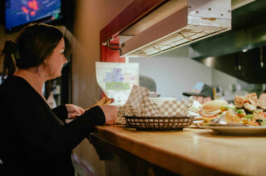 Sequim Gazette photo by Elijah Sussman / Manager Emma Gockerell at the pass-through window in The Oasis Bar and Grill in Sequim on May 5.