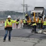 Sequim Gazette photo by Matthew Nash/ Sarah Bradley, a traffic control supervisor with Laborers Local 252, stops vehicles in Rock Plaza as paving work continues on the Sequim Avenue/Sequim-Dungeness Way roundabout on May 6.
