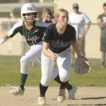 Sequim Gazette photo by Michael Dashiell / Port Angeles Ava-Anne Sheahan takes a lead off first base behind Sequim first baseman Ava Ritter on May 10.