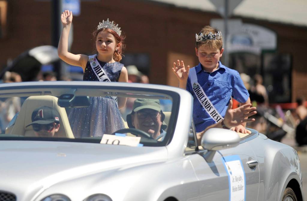 Sequim Gazette photo by Michael Dashiell / Junior Royalty Olive Gockerell and Bennett Castell wave to the crowd at the Sequim Irrigation Festival Grand Parade Saturday afternoon.