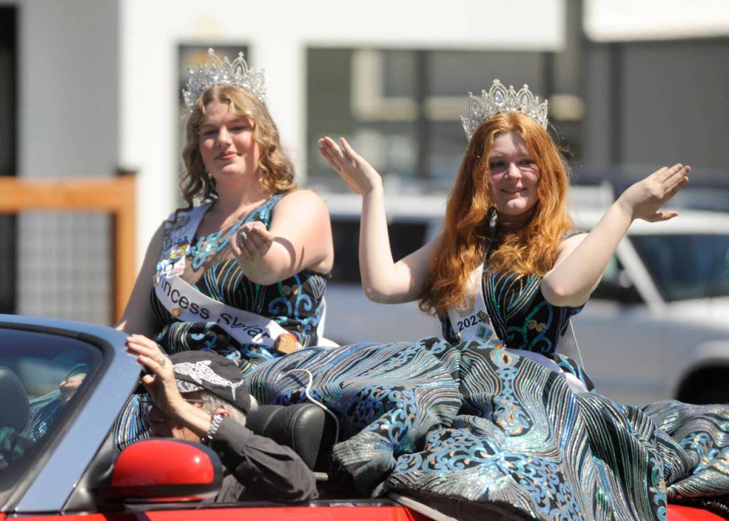 Sequim Gazette photo by Michael Dashiell / 2023 Sequim Irrigation Festival princesses Skylar Kryzworz, left, and Anne Marie Barni say hello to the Sequim Irrigation Festival Grand Parade crowd on Saturday.