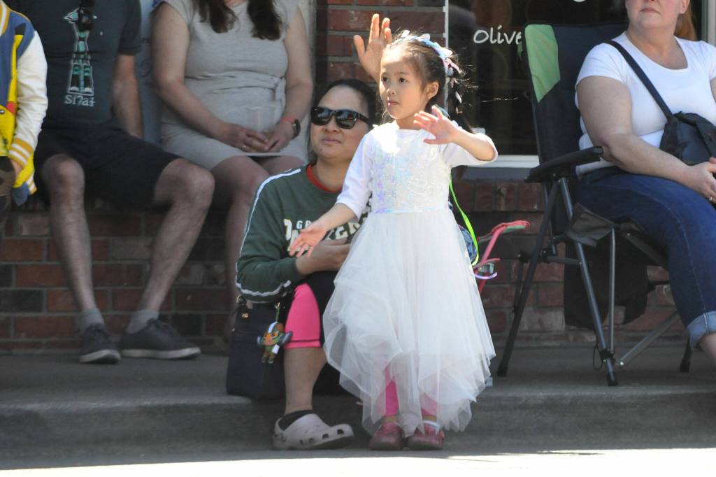 Sequim Gazette photo by Matthew Nash
Five-year-old Nantida Khunmang waves to a float dressed as a princess with her mom Daorueano Utamating. It was their first time at the Grand Parade.