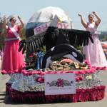 Sequim Gazette photo by Michael Dashiell 
Rhododendron Festival queen Paige Govia and princess Rosie Schmucker wave to the Sequim Irrigation Festival Grand Parade crowd on May 11. The entry took home the festivals Grand Sweepstakes honor.